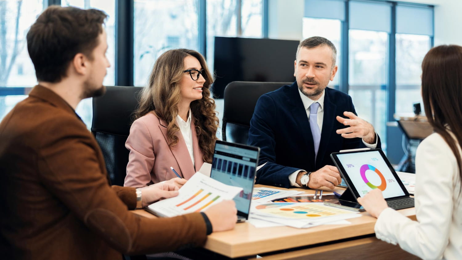 Business team analyzing financial charts and data during a strategy meeting